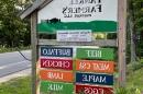 A sign showing a local farm store information